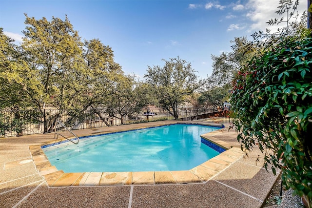 view of swimming pool featuring a fenced in pool, fence, and a patio