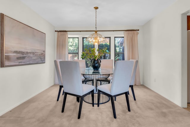 dining space featuring a wealth of natural light, light carpet, and a notable chandelier