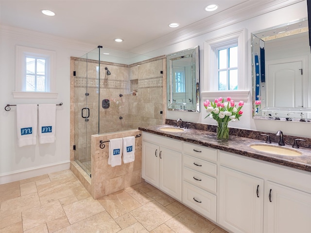 full bath featuring a shower stall, ornamental molding, a sink, and recessed lighting