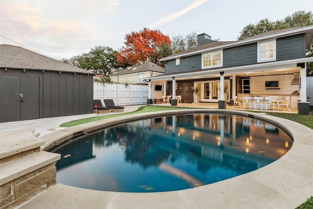 view of pool with a fenced in pool, french doors, fence, and a patio