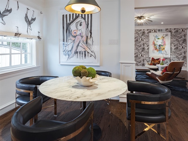 dining space with ornamental molding, baseboards, and wood finished floors