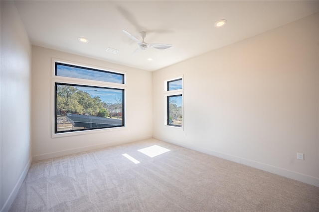 carpeted spare room featuring recessed lighting, ceiling fan, and baseboards