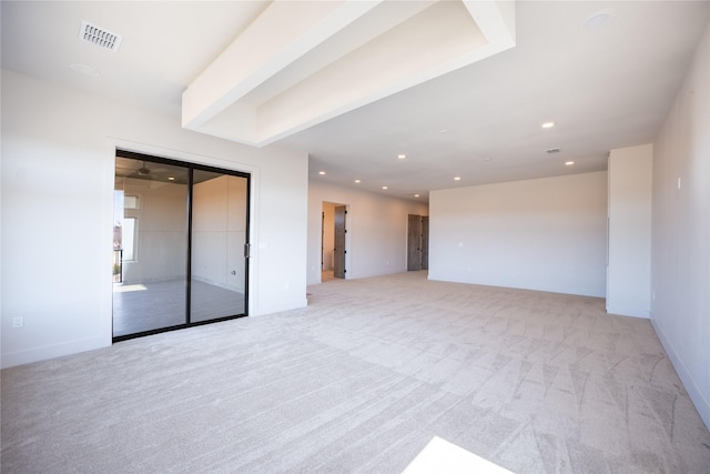 unfurnished room featuring light colored carpet, visible vents, baseboards, and recessed lighting