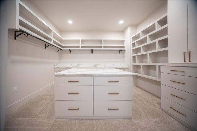 walk in closet featuring light colored carpet