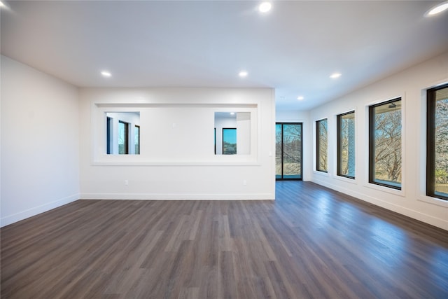 unfurnished living room with dark wood-style floors, baseboards, and recessed lighting