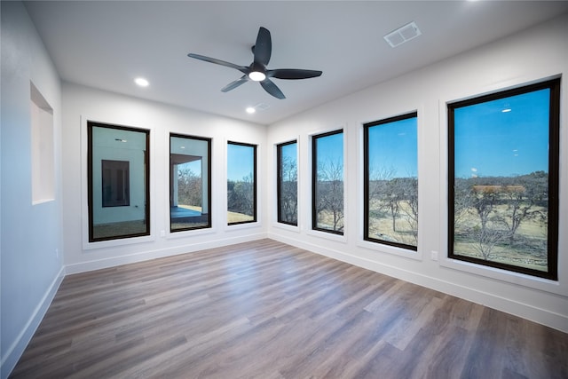 unfurnished sunroom featuring ceiling fan and visible vents