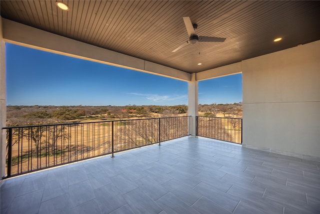 view of patio featuring ceiling fan and a balcony