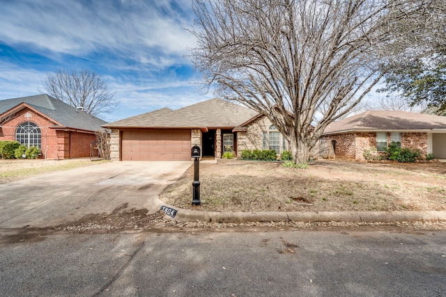 view of front of house with concrete driveway, brick siding, and an attached garage