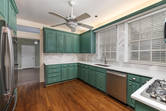 4705 El Campo Ave, Fort Worth, TX 76107 - kitchen featuring stainless steel appliances, dark wood-type flooring, a sink, light countertops, and backsplash