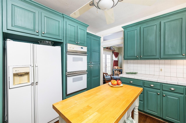 kitchen featuring backsplash, a ceiling fan, dark wood-type flooring, a textured ceiling, and white appliances