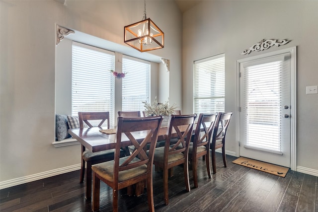 5705 Bender Ridge Dr, Mckinney, TX 75071 - dining space featuring a chandelier, baseboards, dark wood-style flooring, and a high ceiling