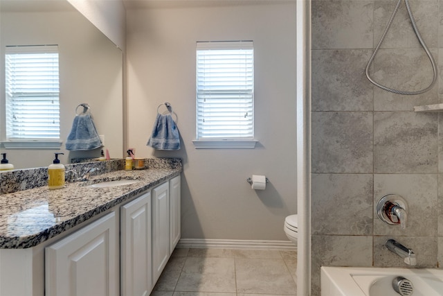 bathroom featuring a healthy amount of sunlight, vanity, baseboards, and tile patterned floors