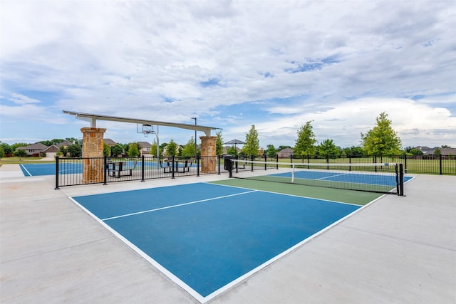 view of tennis court with fence