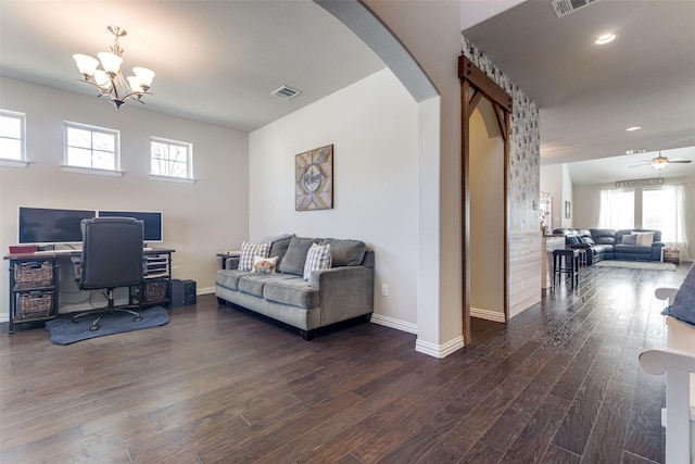 office featuring arched walkways, recessed lighting, wood finished floors, visible vents, and baseboards