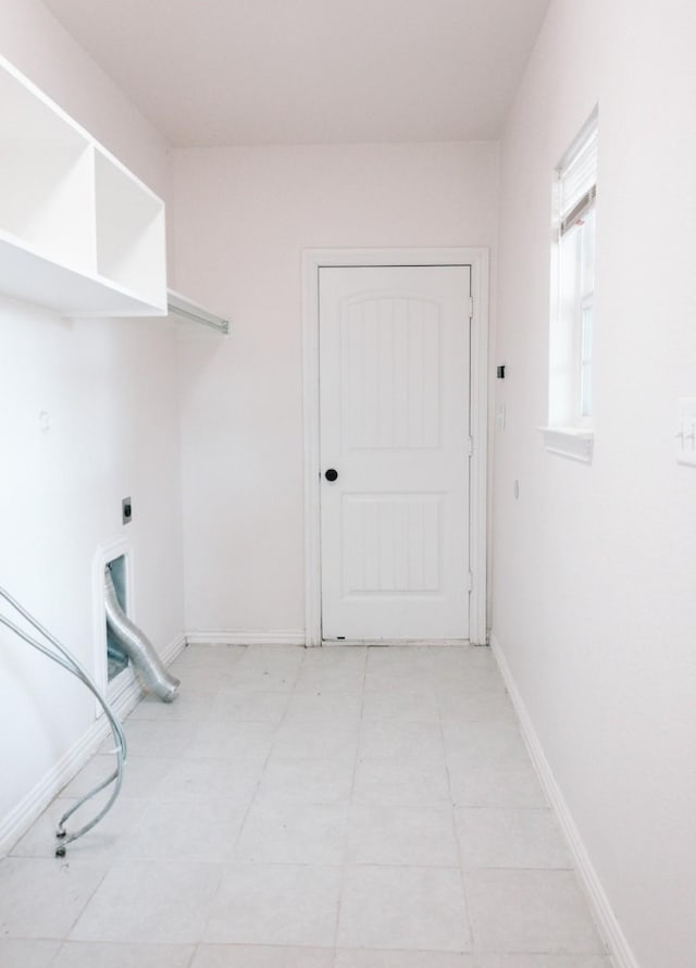 laundry room with laundry area, electric dryer hookup, and baseboards