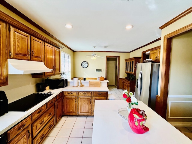 kitchen with black microwave, stainless steel fridge, under cabinet range hood, and light tile patterned floors