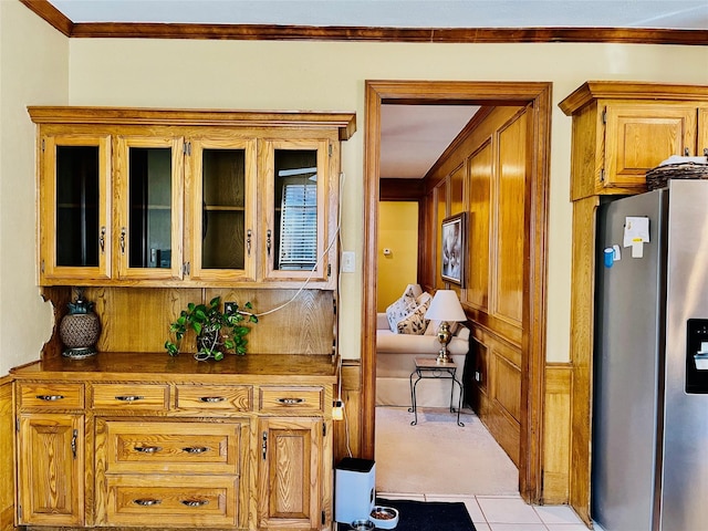 hall with ornamental molding and light tile patterned flooring