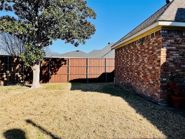 view of yard with a fenced backyard