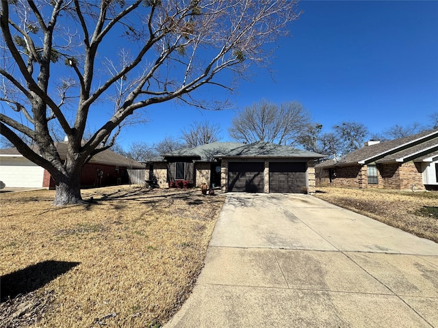 ranch-style house with a garage and driveway