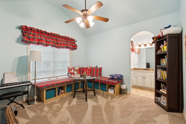 recreation room featuring a ceiling fan, lofted ceiling, and light carpet