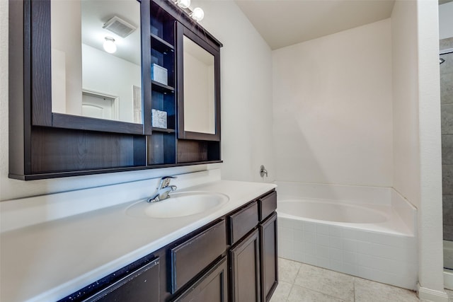 full bathroom with a relaxing tiled tub, visible vents, vanity, tile patterned floors, and walk in shower