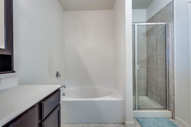 full bath featuring a garden tub, a shower stall, and vanity