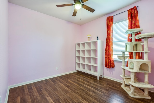 unfurnished bedroom featuring a ceiling fan, baseboards, and wood finished floors