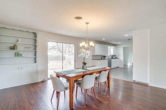 dining room with dark wood-type flooring, recessed lighting, a chandelier, and visible vents