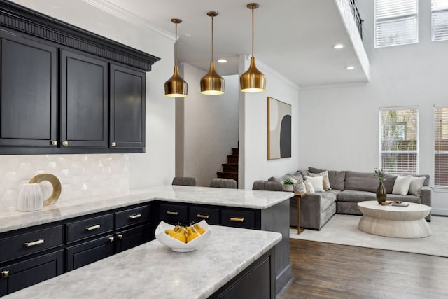 kitchen with decorative light fixtures, tasteful backsplash, recessed lighting, ornamental molding, and dark wood-type flooring