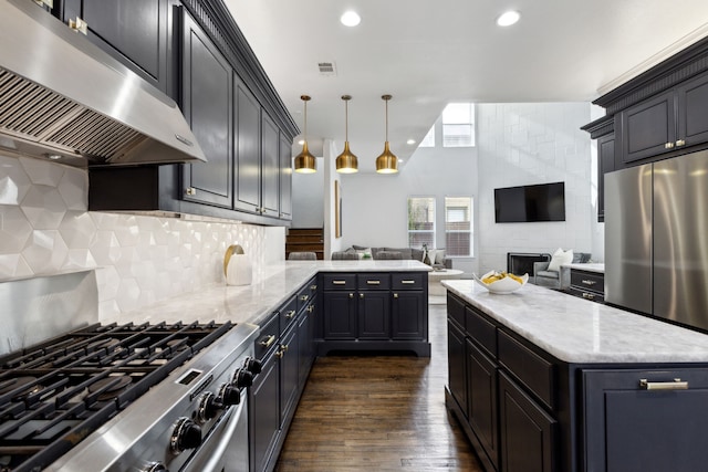 kitchen featuring range hood, dark wood finished floors, tasteful backsplash, visible vents, and open floor plan