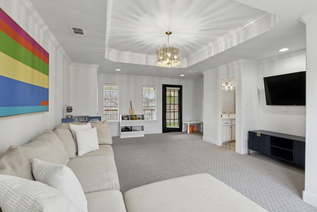 living room featuring carpet floors, a tray ceiling, visible vents, an inviting chandelier, and baseboards