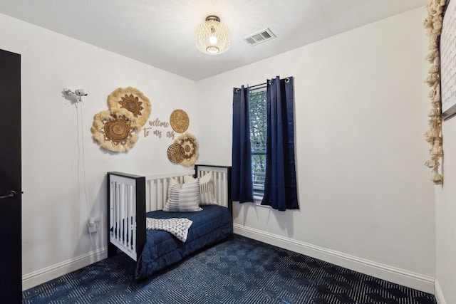 carpeted bedroom featuring visible vents and baseboards