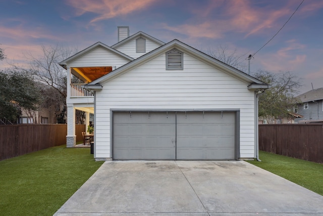 garage with concrete driveway and fence