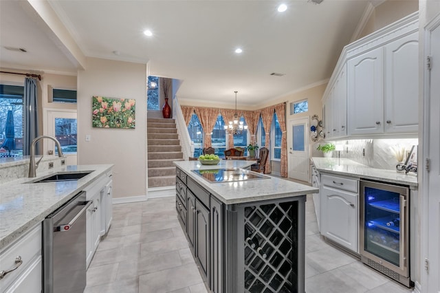 kitchen with wine cooler, black electric cooktop, a sink, ornamental molding, and stainless steel dishwasher