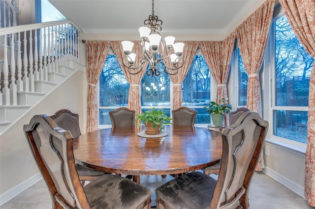 dining space with a healthy amount of sunlight, ornamental molding, and a notable chandelier