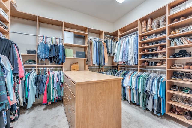 walk in closet featuring light colored carpet