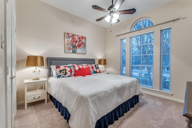 carpeted bedroom featuring ceiling fan and baseboards