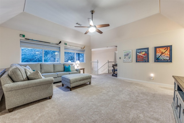 living area featuring lofted ceiling, a ceiling fan, visible vents, and light colored carpet