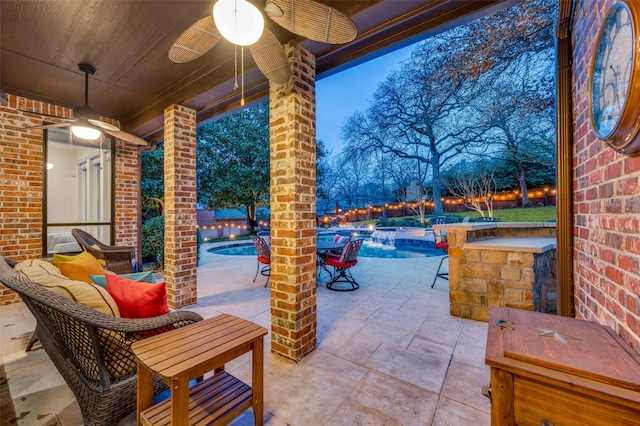 view of patio / terrace featuring an outdoor pool and a ceiling fan