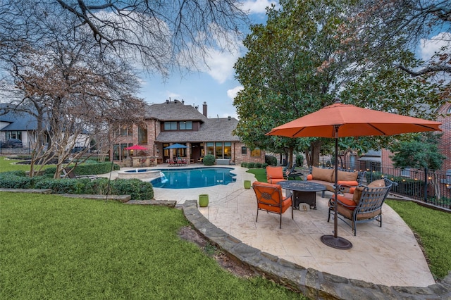 view of swimming pool with an outdoor fire pit, a fenced in pool, a lawn, fence, and a patio area