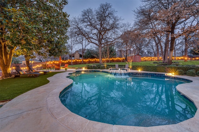 view of swimming pool featuring a patio, a fenced backyard, a storage shed, an outdoor structure, and a fenced in pool