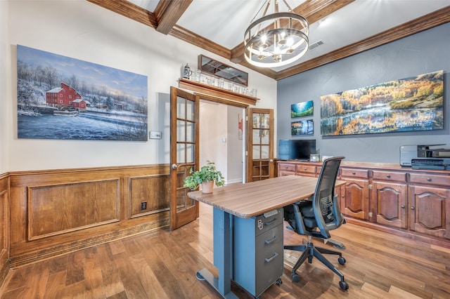 office with a wainscoted wall, a notable chandelier, ornamental molding, and wood finished floors