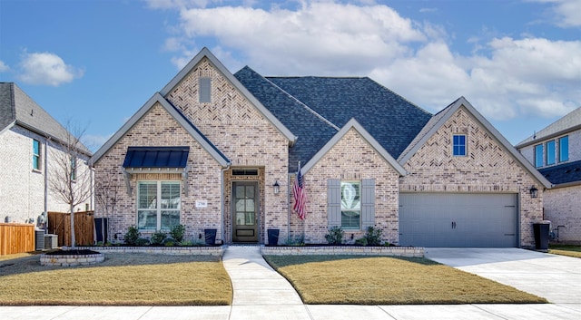 view of front of house featuring brick siding, concrete driveway, a front yard, fence, and a garage