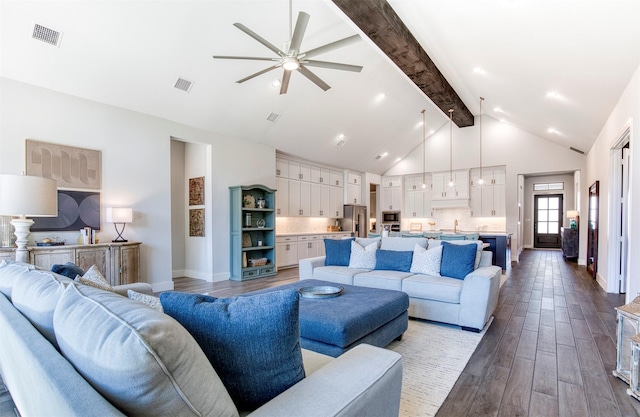 living area with beam ceiling, visible vents, dark wood finished floors, and baseboards