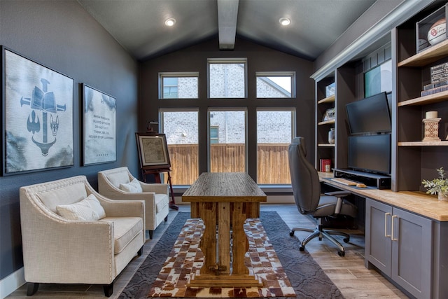 office space featuring vaulted ceiling with beams, light wood finished floors, and built in study area