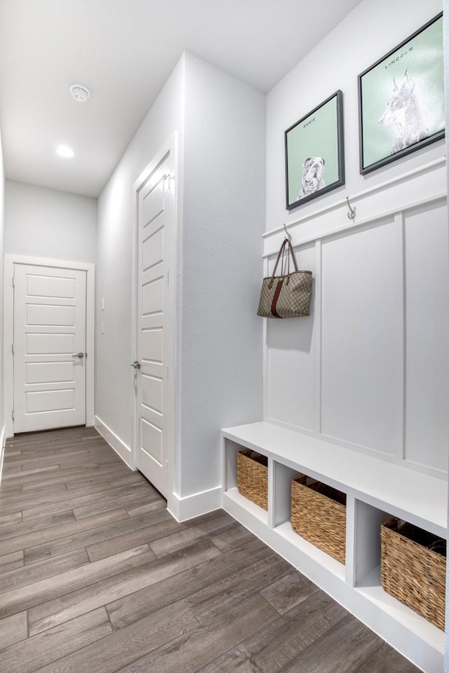 mudroom with wood finished floors and baseboards