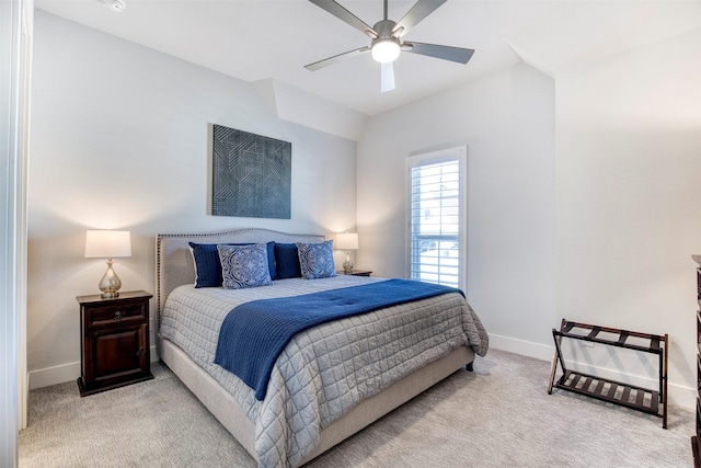 carpeted bedroom featuring ceiling fan, baseboards, and vaulted ceiling