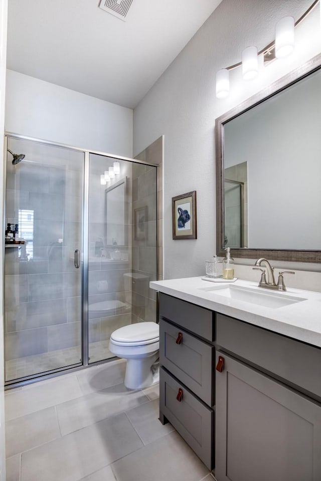 bathroom featuring visible vents, toilet, tile patterned floors, vanity, and a shower stall