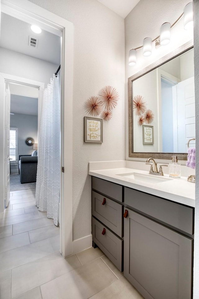 bathroom with tile patterned floors, visible vents, and vanity