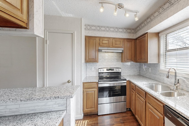 kitchen with dark wood-style floors, electric stove, a sink, dishwasher, and under cabinet range hood